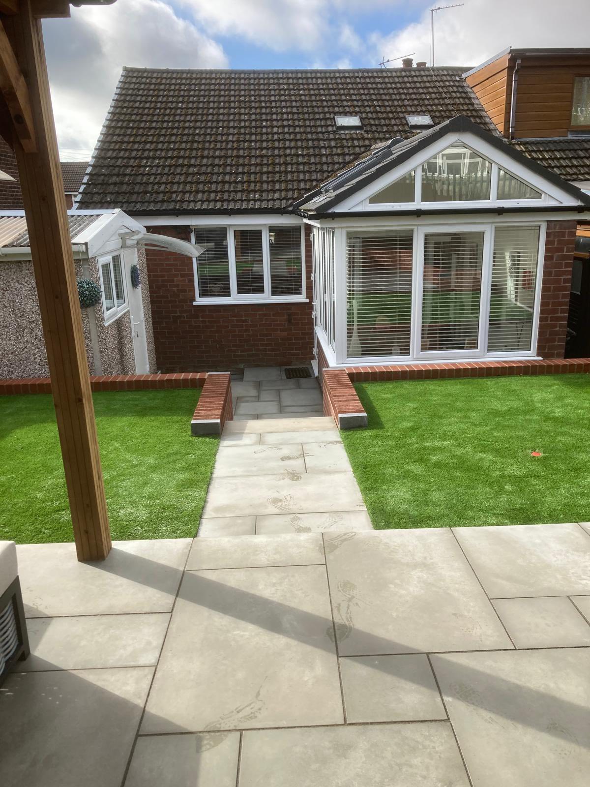 Recently laid concrete paving for a pathway and paito